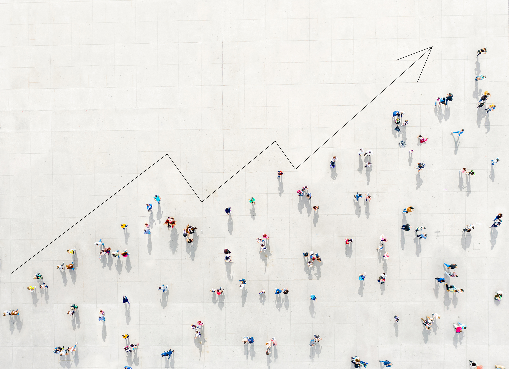 A crowd viewed from above forming a growth graph, symbolizing how marketing agencies use data analytics for client reporting, creating reports, and customer segmentation to unlock growth.