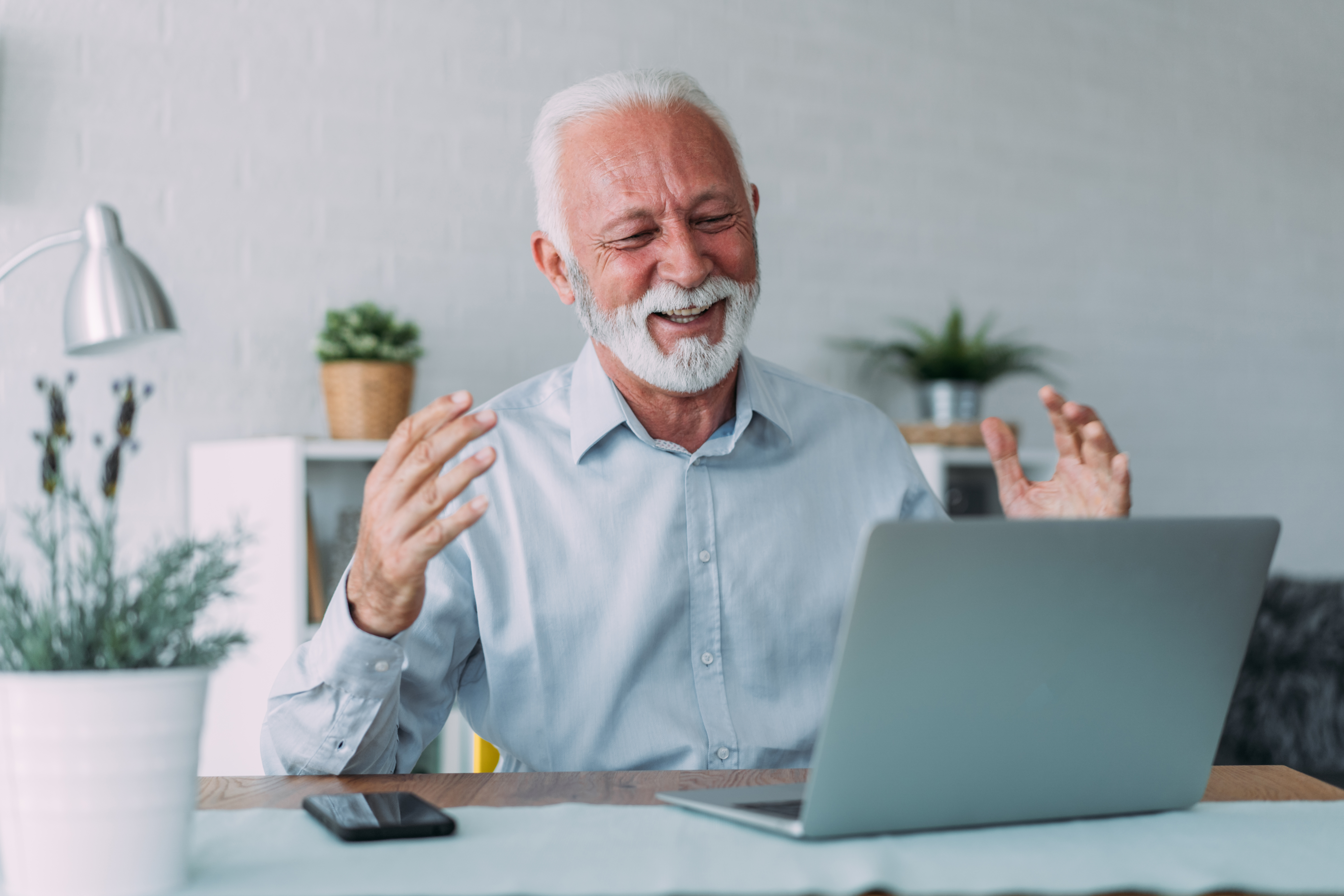 Businessman participating in a video call in an office setting, engaged in discussing training programs for insurance agents, highlighting a professional environment with focus on insurance sales training and team collaboration.
